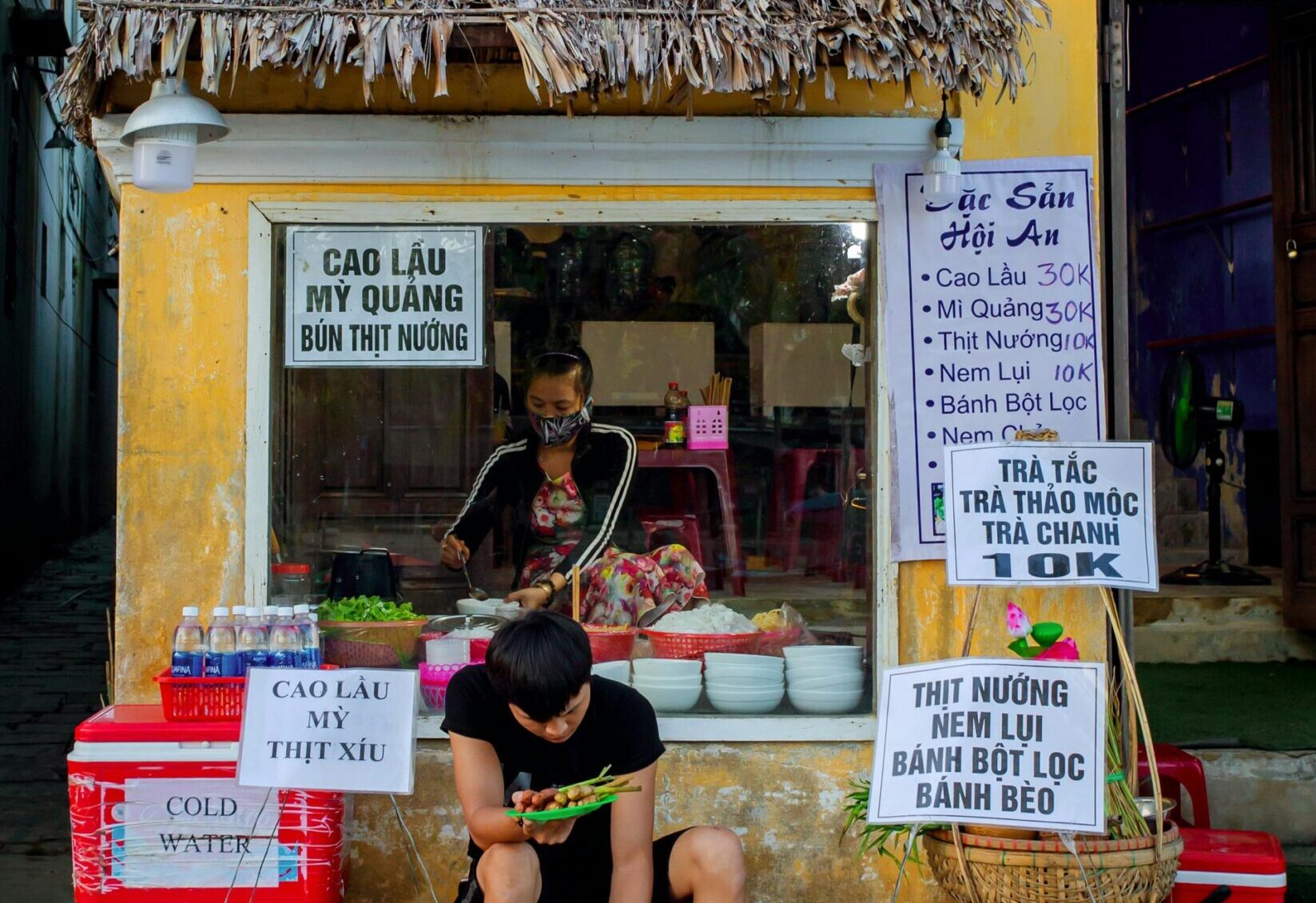 Street food vendor in Hoi An selling local specialties.