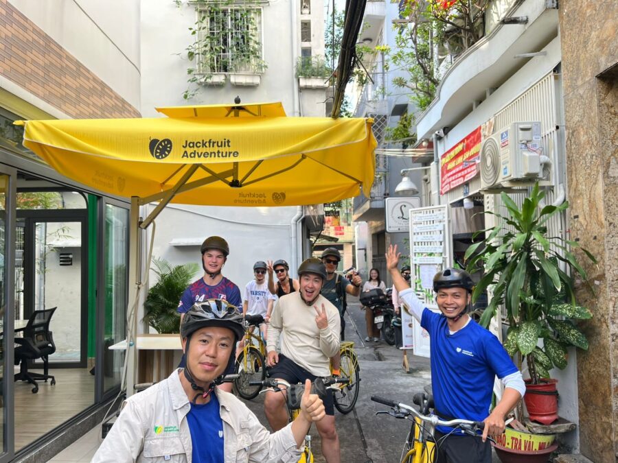 Travelers and guides prepare for a cycling tour through hidden alleys during one day in Ho Chi Minh City - Jackfruit 