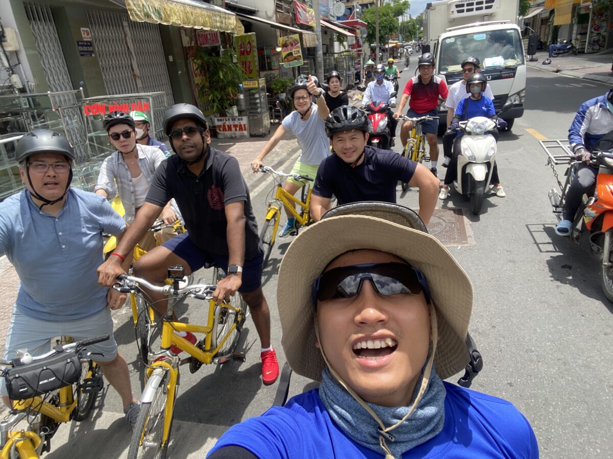 A local guide leads cyclists through traffic during one day in Ho Chi Minh City - Jackfruit
