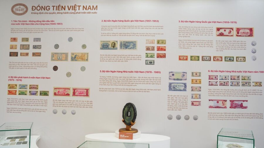 Museum display of Vietnamese banknotes from the post-1975 period, including currency issued after national reunification.