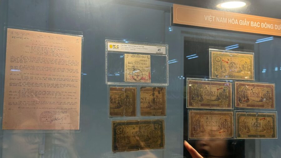 Indochina banknotes displayed in a glass case at the Vietnamese currency exhibition, showing colonial-era currency used in Vietnam.