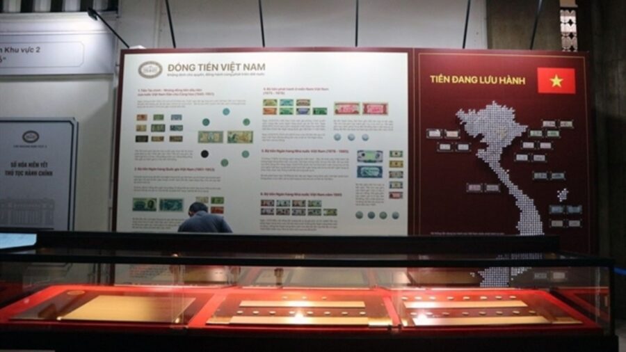 Display panels and glass cases showing Vietnamese coins and circulating currency at the Vietnamese currency exhibition in Ho Chi Minh City.