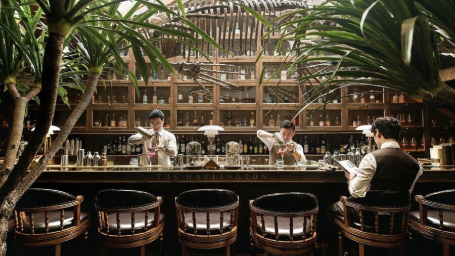 Museum-inspired interior of The Haflington cocktail bar in Hanoi with bartenders preparing drinks
