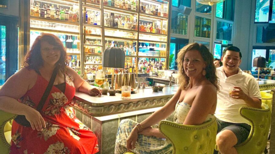 Foreign tourists smiling happily inside Angelina Bar