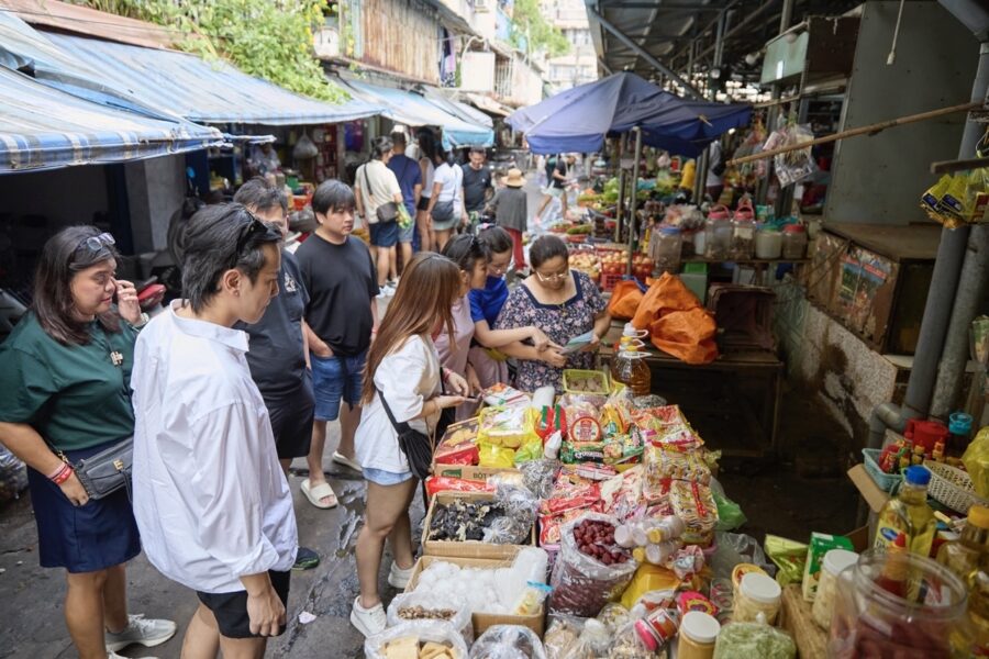 Exploring a vibrant market during a Vietnamese cooking class.