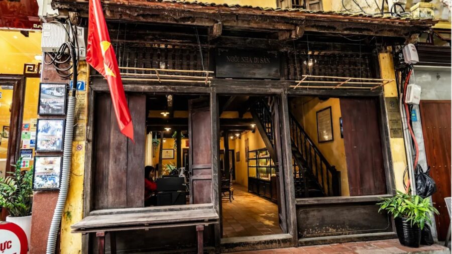 Traditional wooden facade and tiled roof of the hanoi ancient house on Ma May street