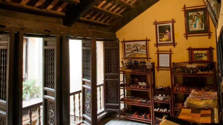 Exhibition room displaying traditional handicrafts and paintings at a hanoi ancient house