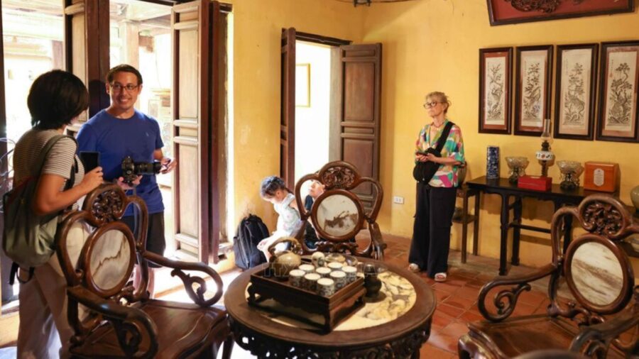 Tourists are contemplating and stepping back in time in the ancient setting of the old house.