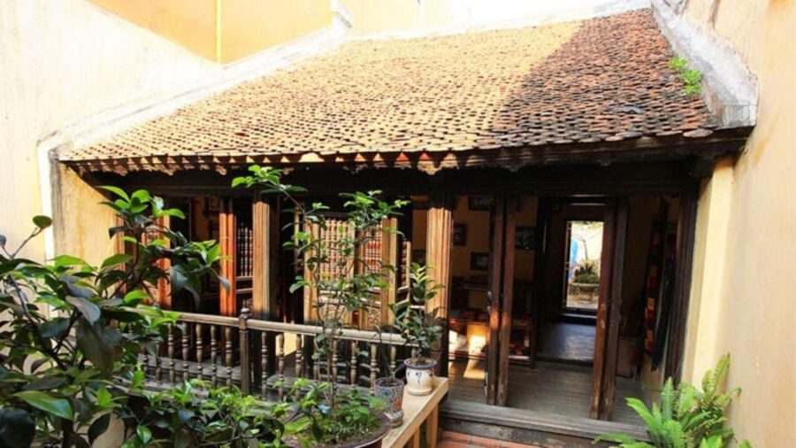 Sunlit courtyard area filled with green plants inside a hanoi ancient house