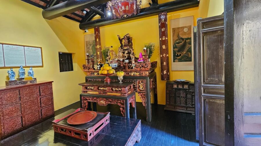 Solemn ancestral altar space with antique worship items at a hanoi ancient house