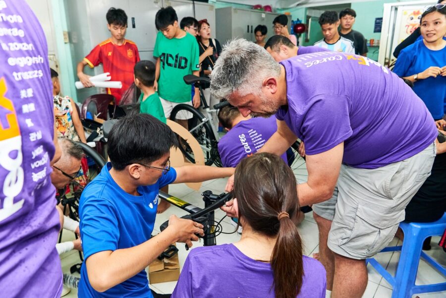 Corporate team participating in problem-solving activities to improve teamwork and collaboration in Vietnam.