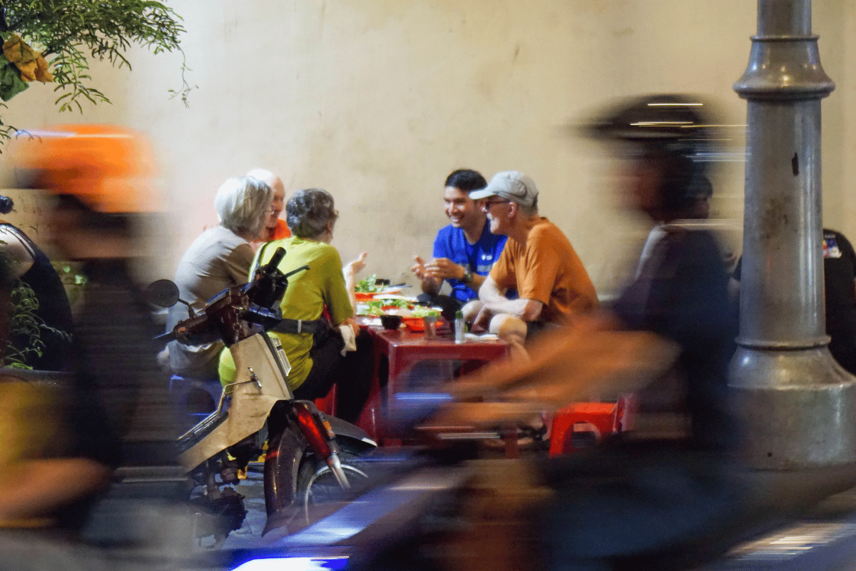 Travelers enjoying a Saigon Foodie Night Ride tour with Jackfruit Adventure in Cho Lon.