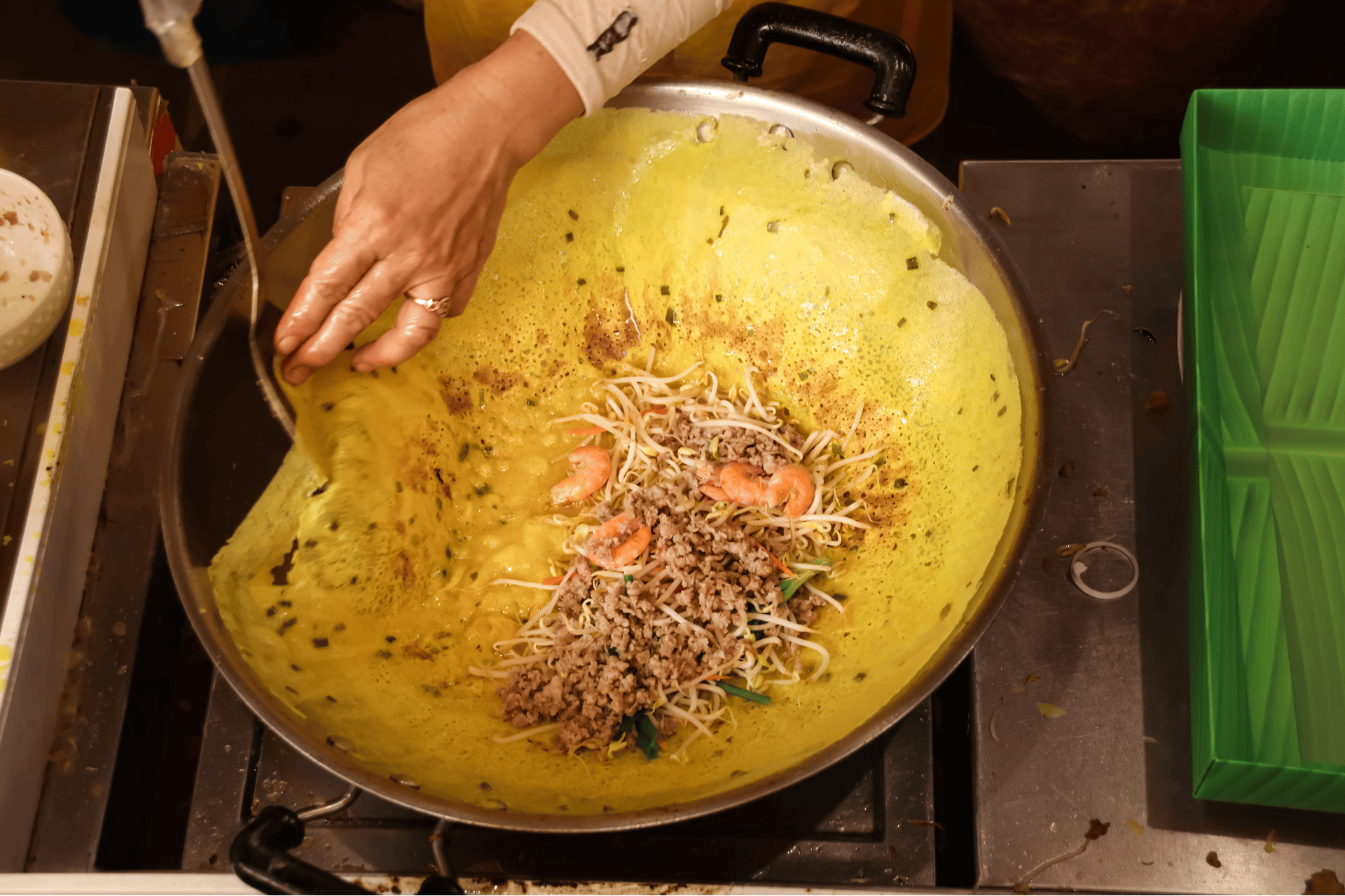 Best banh xeo in Saigon - making crispy banh xeo over high-heat wok - Jackfruit Adventure
