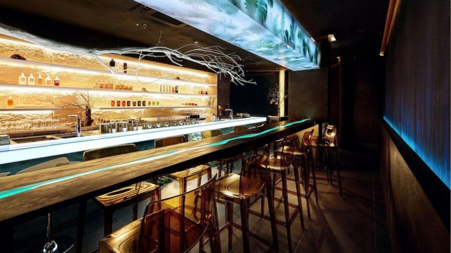 Interior of USE bar in Hanoi with a modern glowing bar counter and minimalist design