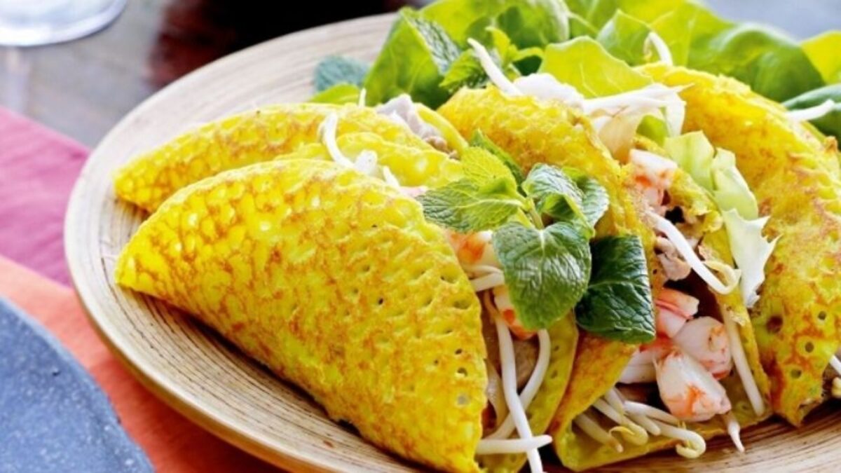 bánh khoái served with herbs, lettuce, shrimp, pork, and dipping sauce - hue food - Jackfruit