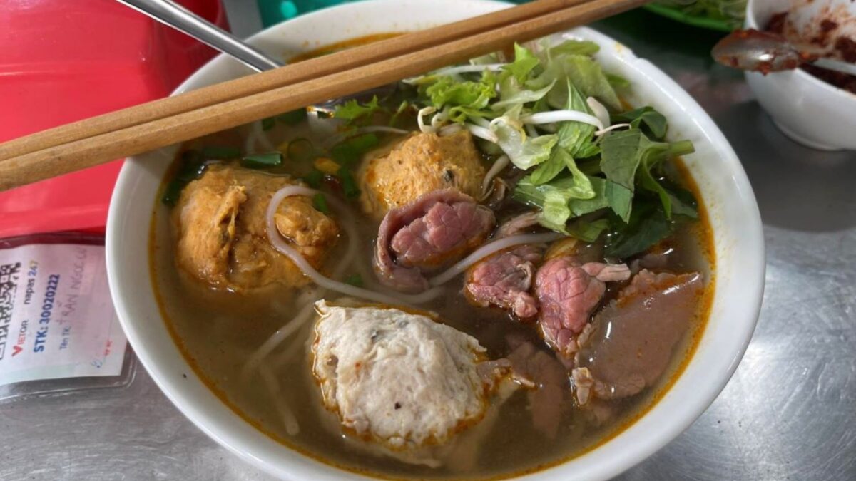 bún bò Huế with beef, pork, herbs, and rich orange broth - hue food - Jackfruit