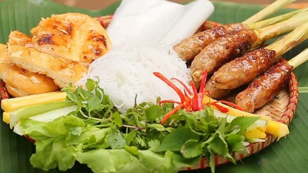 nem lụi with grilled pork skewers, rice paper, herbs, and dipping sauce - hue food - Jackfruit
