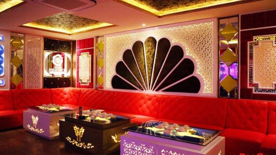 Stylish private karaoke room with red seating for karaoke in Ho Chi Minh City _ Jackfruit