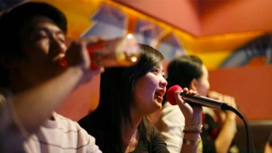 Woman singing into a microphone during karaoke in Ho Chi Minh City_ Jackfruit