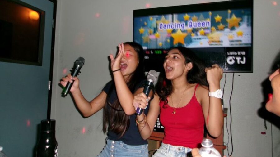Two travelers singing together in a private room for karaoke in Ho Chi Minh City_ Jackfruit