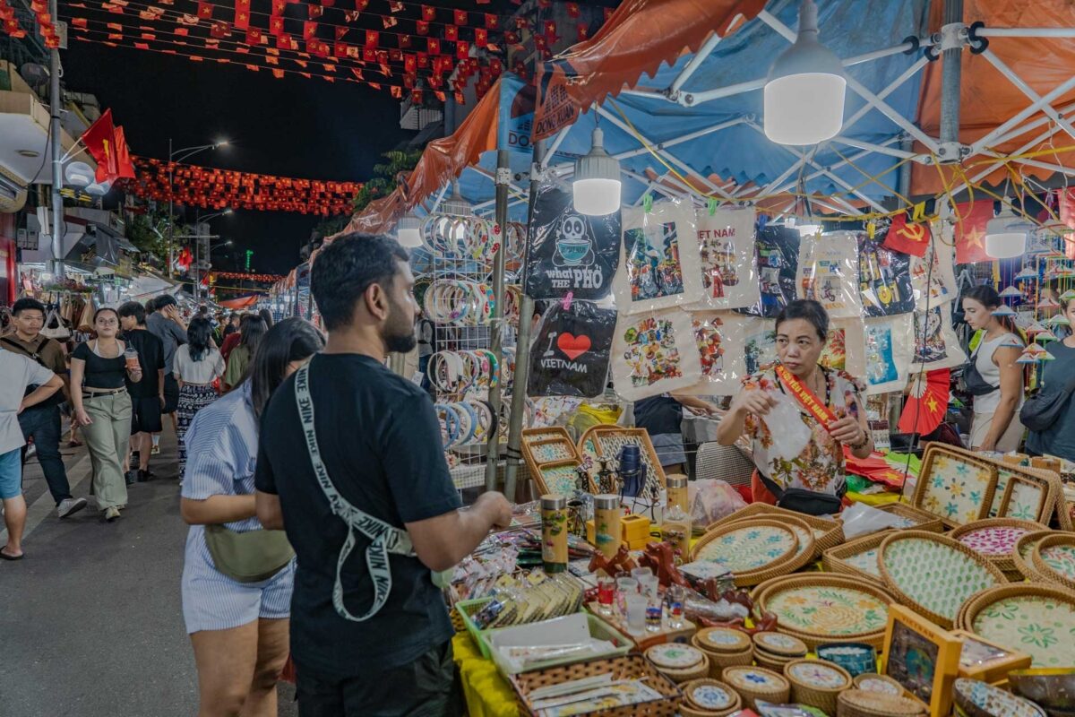 Pedestrian street atmosphere at the Hanoi Old Quarter night market with vendors - Jackfruit Adventure