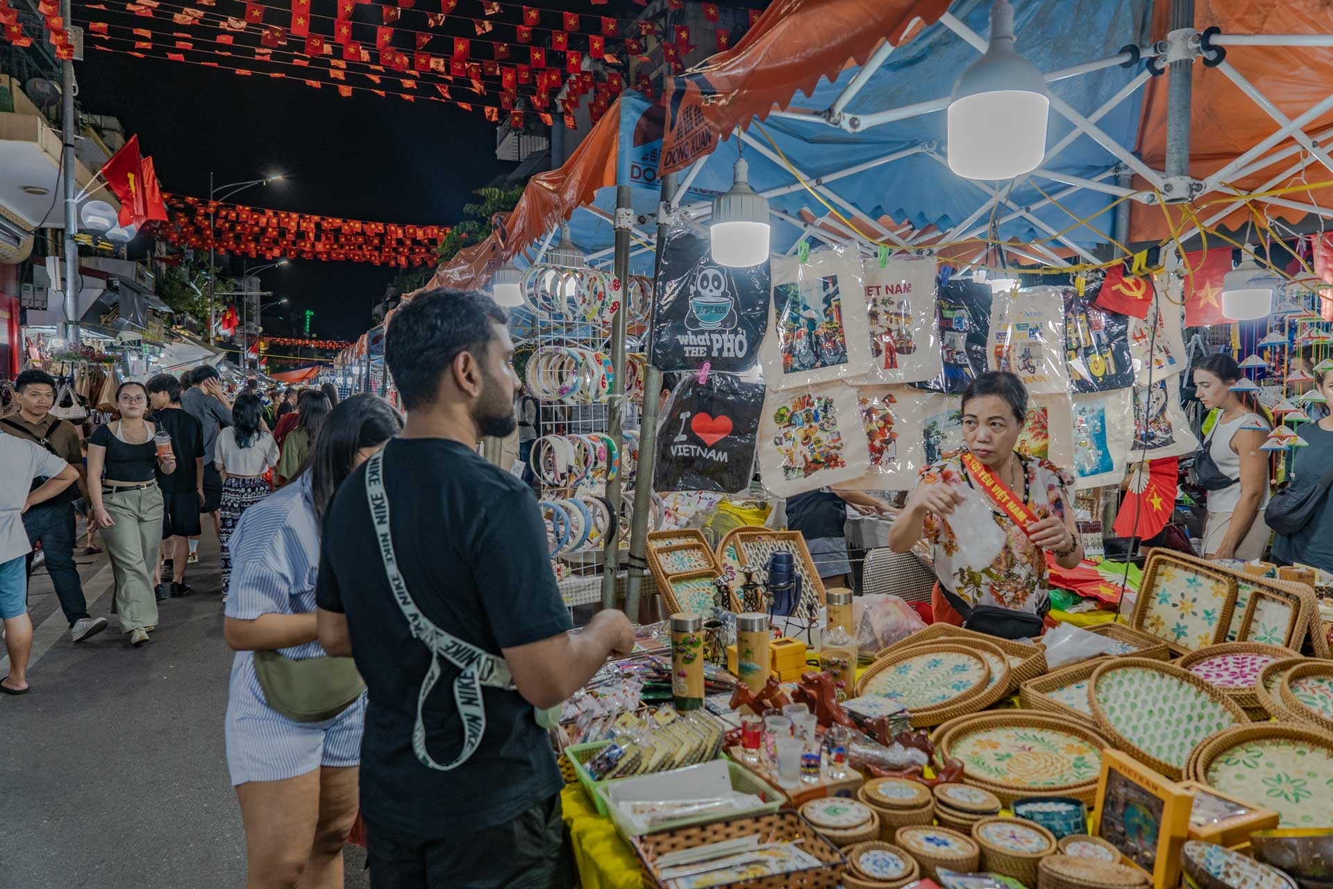 Pedestrian street atmosphere at the Hanoi Old Quarter night market with vendors - Jackfruit Adventure