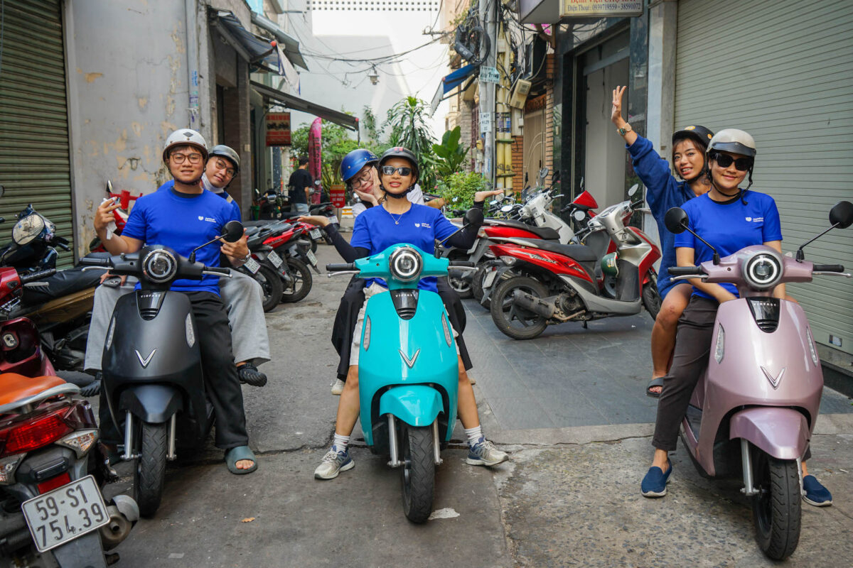 tourists riding through a Saigon neighborhood by e-motorbike_eco tour_Jackfruit Adventure